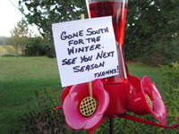 Sign on hummingird feeder: Gone South for Winter!